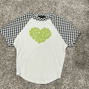 White tee with black and white checkered shoulders, green “No, Thank You” text
